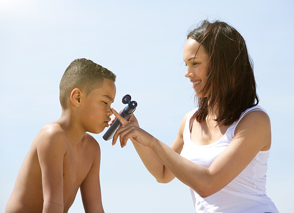 Mother applying sunscreen to a child
