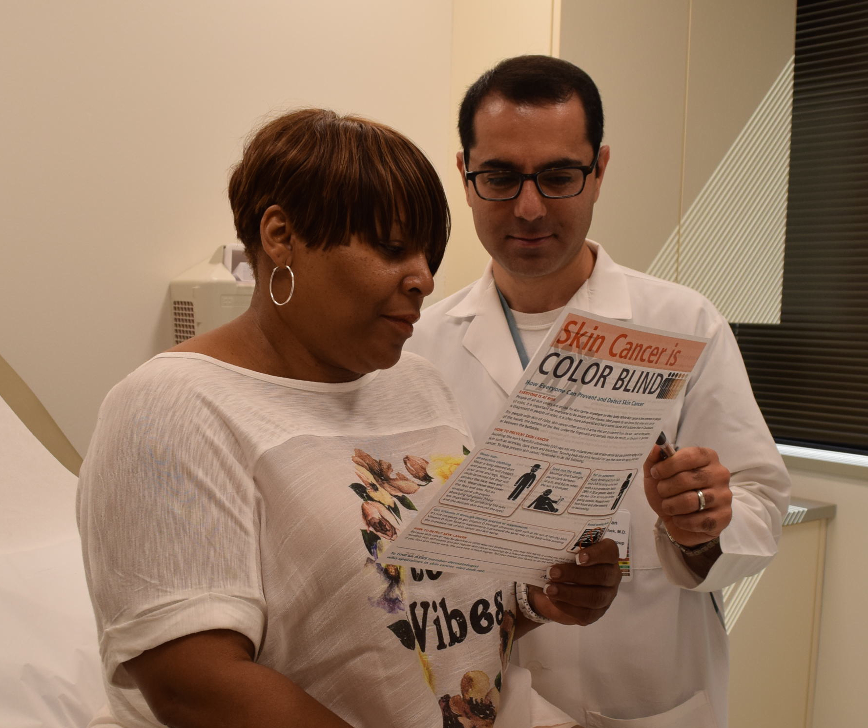 Arash Koochek, MD, MPH, providing skin cancer information at a skin cancer screening.