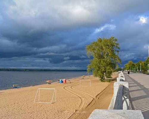 Sandy beach with dark rain clouds forming in the sky