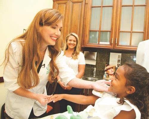 Dr with young patient in an office setting